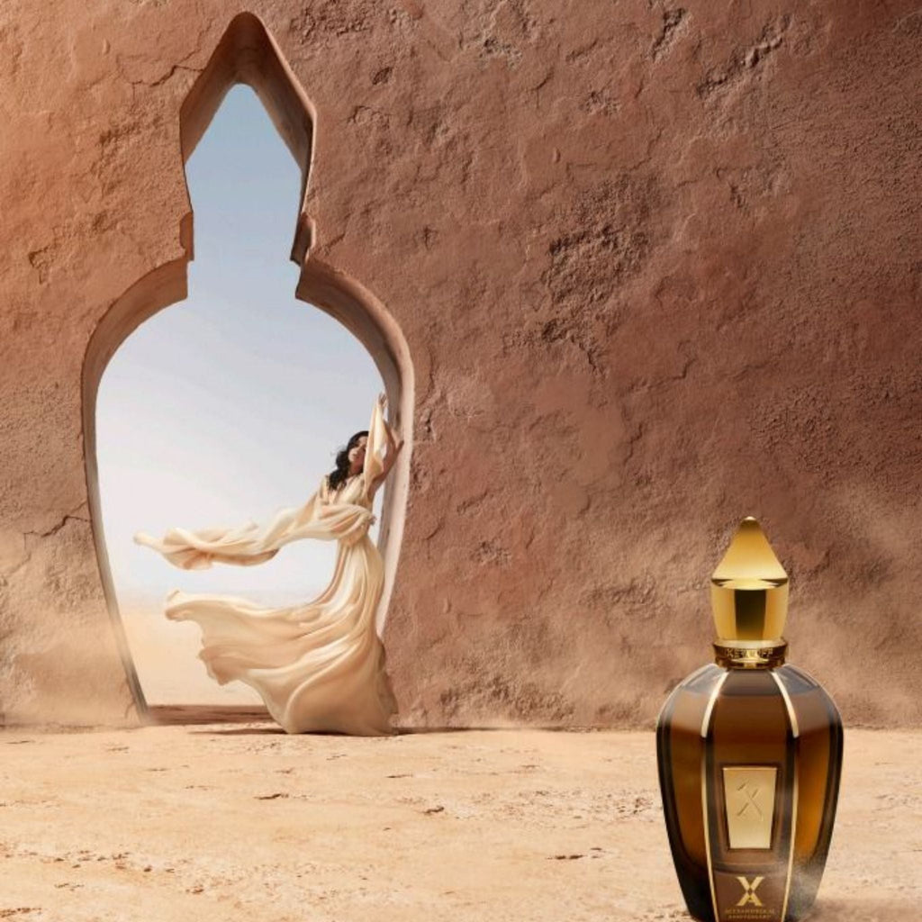 Refect Beauty Xerjoff Oud Stars Alexandria II perfume bottle in a desert setting with a woman in a flowing dress