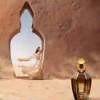 Refect Beauty Xerjoff Oud Stars Alexandria II perfume bottle in a desert setting with a woman in a flowing dress