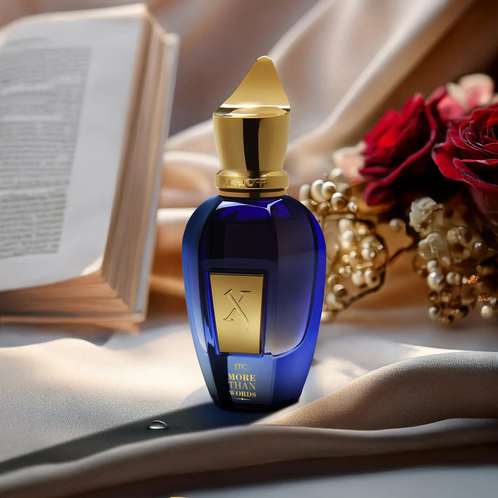 Refect Beauty Xerjoff More Than Words perfume bottle in deep blue glass with gold cap on draped silk with roses