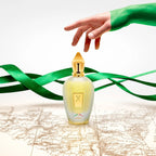 Refect Beauty Xerjoff Naxos Eau de Parfum bottle on a vintage map with green ribbons and a hand reaching down