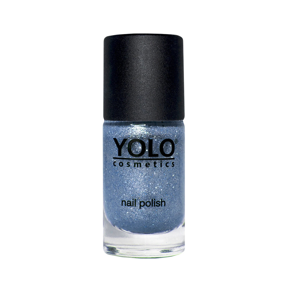 Refect Beauty Yolo glitter nail polish in a shimmering blue shade with a black cap in a glass bottle.