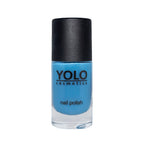 Refect Beauty Yolo Nail Polish in a vibrant creamy blue shade with a glossy finish in a glass bottle.