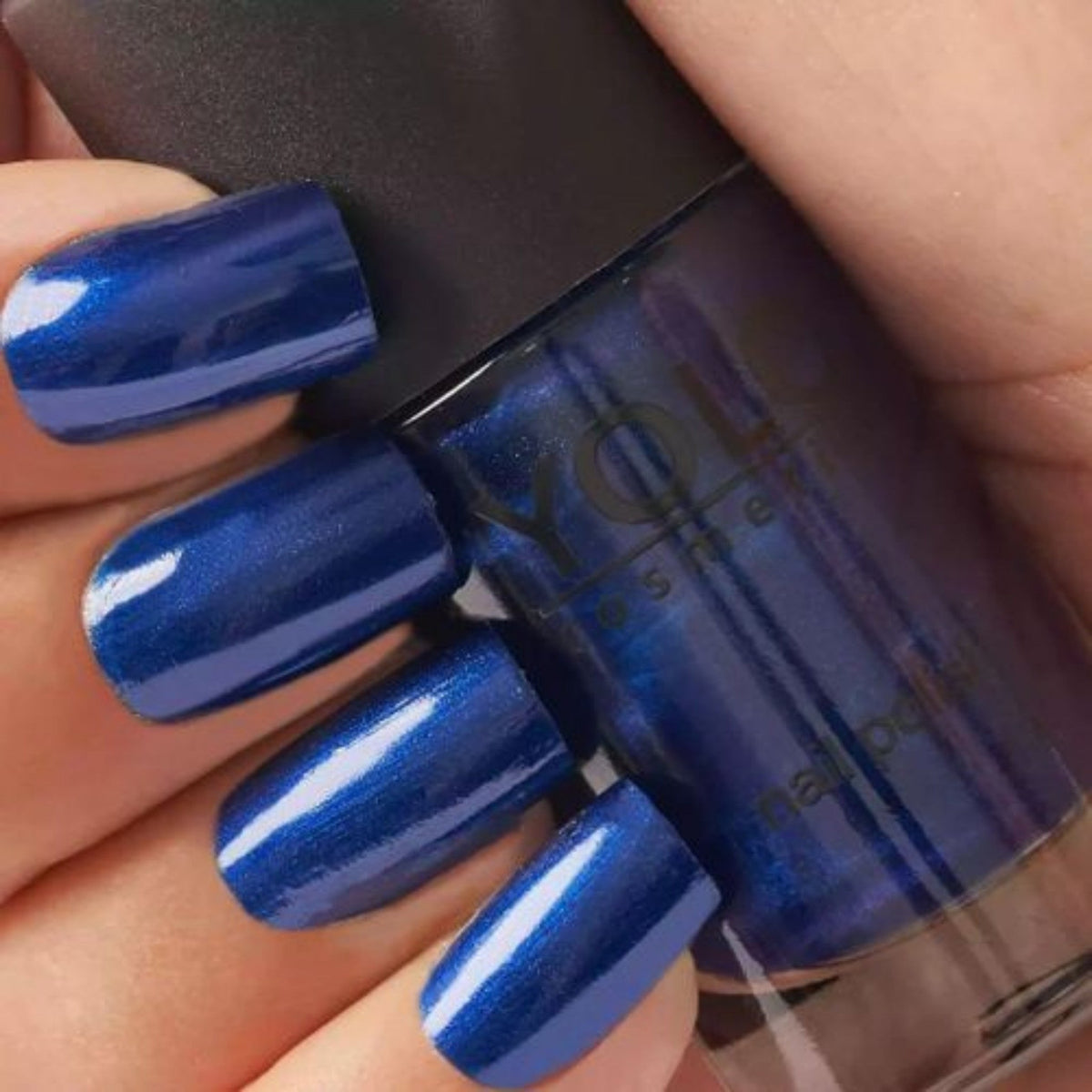 Refect Beauty Yolo pearl nail polish in a deep shimmering blue shade applied on fingernails