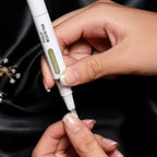 Refect Beauty Yolo Booster serum pen applying nourishing oil to a cuticle on a black silk background