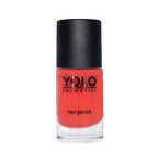 Refect Beauty Yolo Nail Polish Creamy in a vibrant coral red shade with a smooth, glossy finish in a glass bottle.