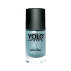 Refect Beauty Yolo glitter nail polish in a shimmering light blue shade with a black cap in a glass bottle.