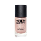 Refect Beauty Yolo glitter nail polish in a soft shimmering pink shade with a black cap in a glass bottle.