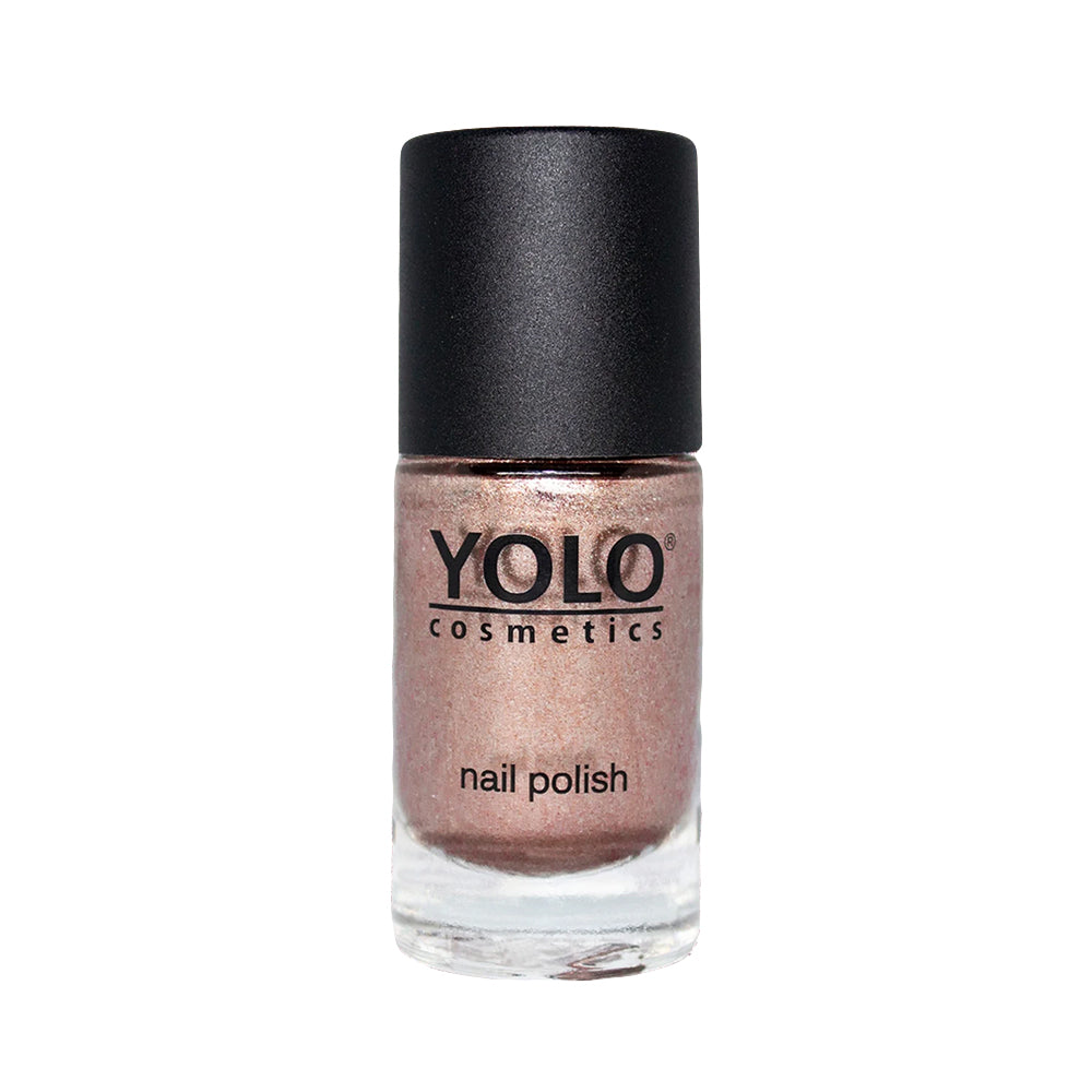 Refect Beauty Yolo glitter nail polish in a shimmering metallic rose gold shade in a glass bottle with a black cap.