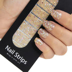 Refect Beauty Yolo nail strips featuring sparkling gold glitter on a hand with a finished manicure