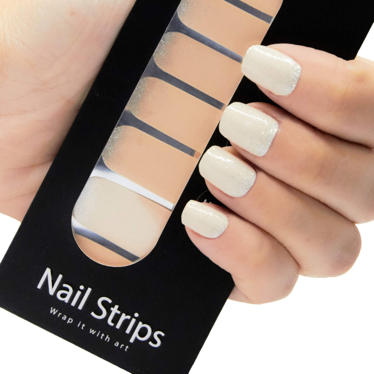 Refect Beauty Yolo glitter nail strips applied to fingers, showing a smooth, sparkling off-white manicure.