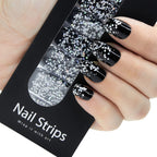 Refect Beauty Yolo nail strips featuring a black base with silver glitter gradient design applied to fingers