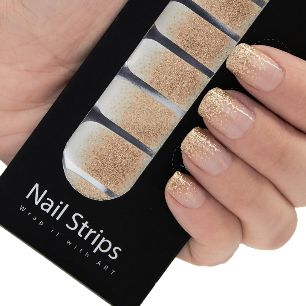 Refect Beauty Yolo nail strips featuring a gold glitter gradient design applied to a hand for a salon-style manicure.