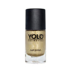 Refect Beauty Yolo gold glitter nail polish in a glass bottle with a black cap for a sparkling manicure finish.