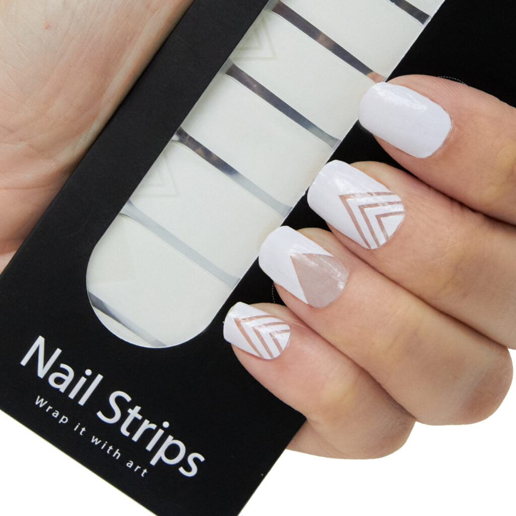Refect Beauty Yolo nail strips featuring white and metallic geometric chevron designs applied to fingernails