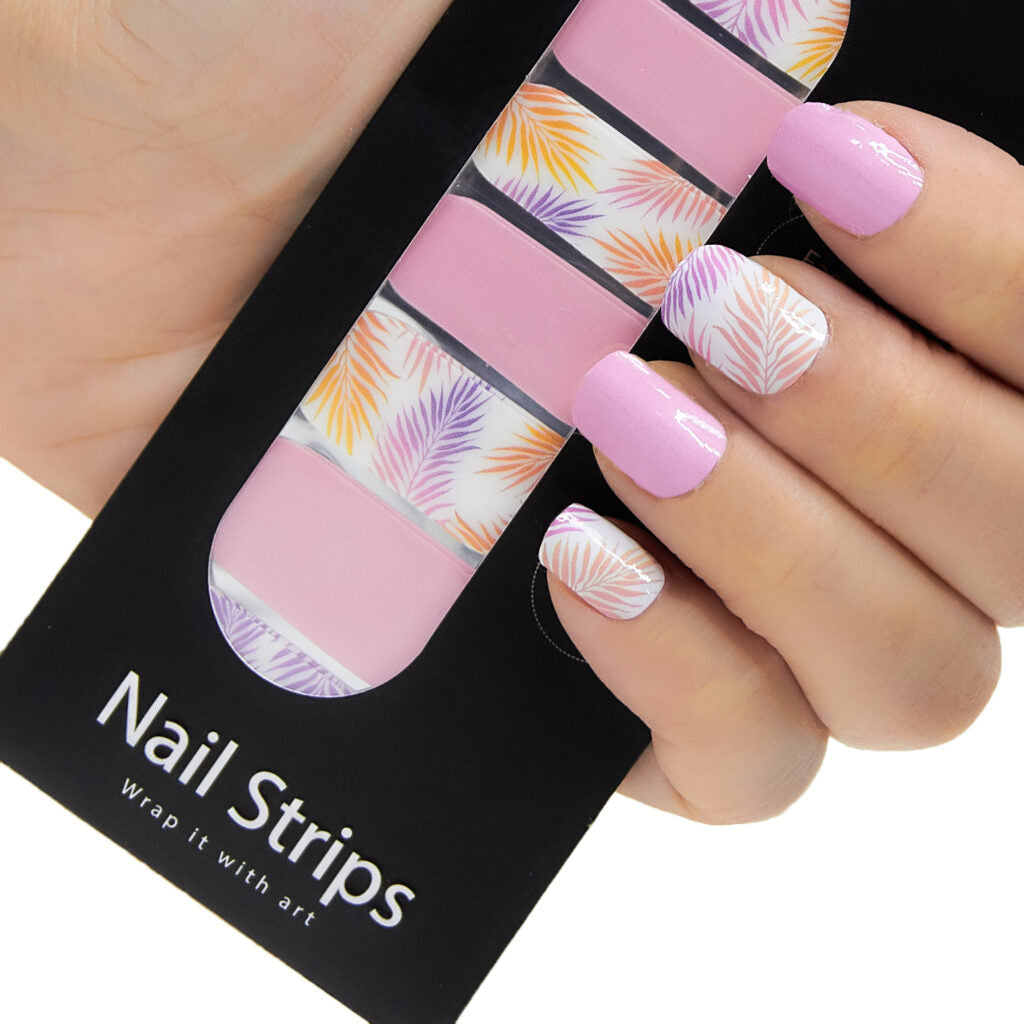 Refect Beauty Yolo nail strips featuring pink solid and tropical palm leaf patterns applied to manicured fingernails
