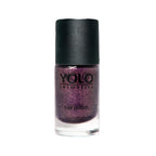 Refect Beauty Yolo glitter nail polish in a deep purple shade with a black cap, perfect for a festive manicure.