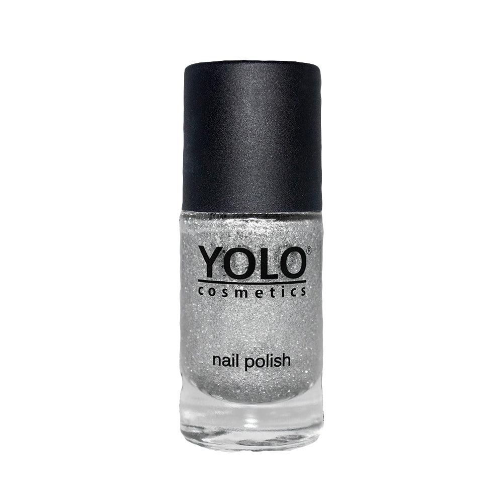 Refect Beauty Yolo silver glitter nail polish in a clear glass bottle with a black cap.