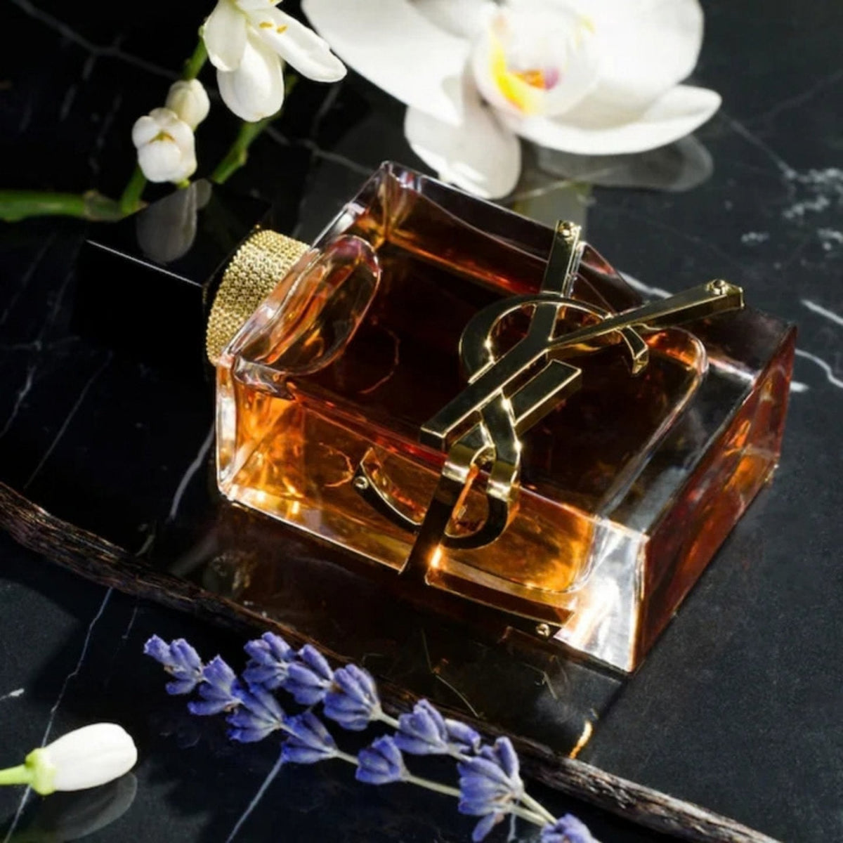 Refect Beauty Yves Saint Laurent Libre Eau de Parfum Intense bottle with gold logo, lavender, and orchid on marble.