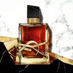 Refect Beauty Yves Saint Laurent Libre Le Parfum bottle with gold YSL logo on a marble and gold background