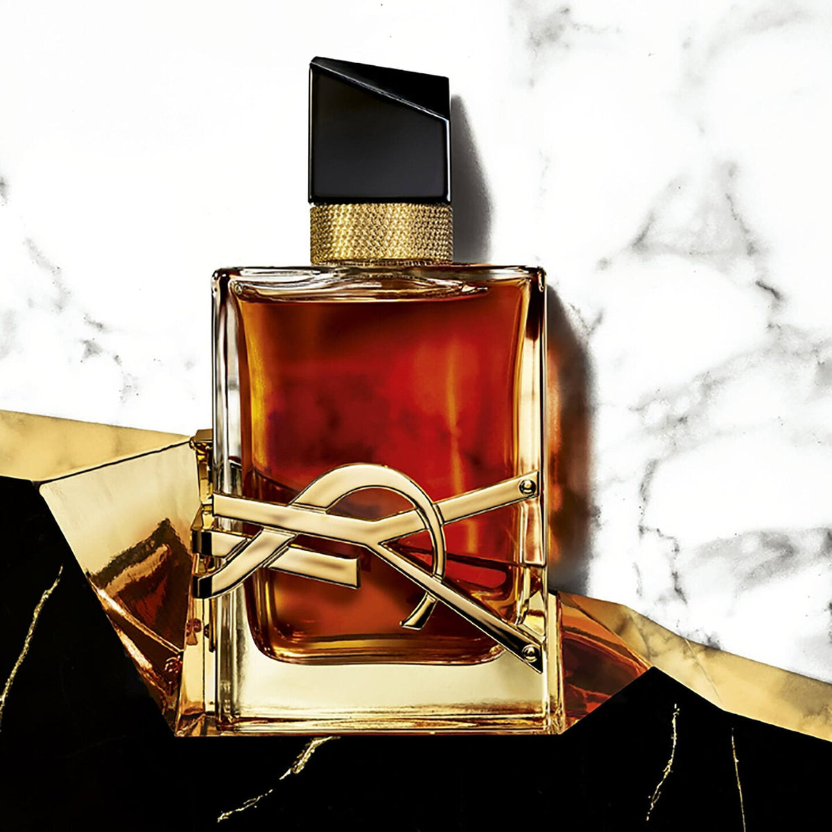 Refect Beauty Yves Saint Laurent Libre Le Parfum bottle with gold YSL logo on a marble and gold background