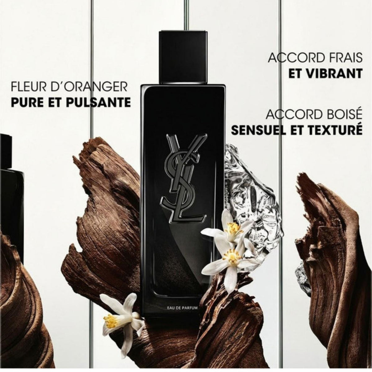 Refect Beauty Yves Saint Laurent Myslf Eau de Parfum bottle with orange blossoms and driftwood on a white background