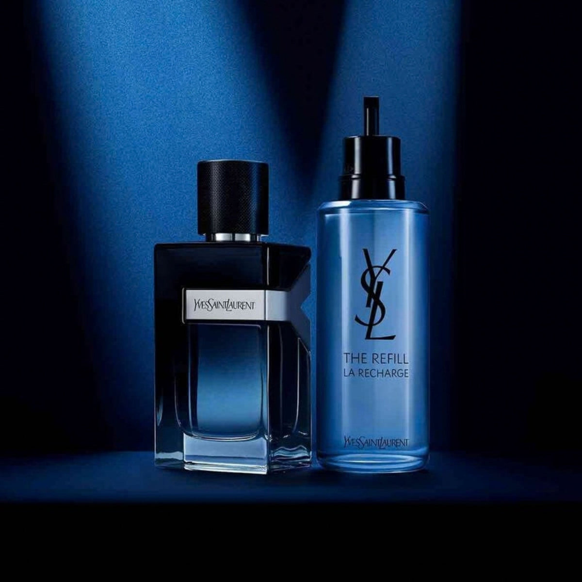 Refect Beauty Yves Saint Laurent Y Eau de Parfum bottle and refill container in a dark blue studio setting.