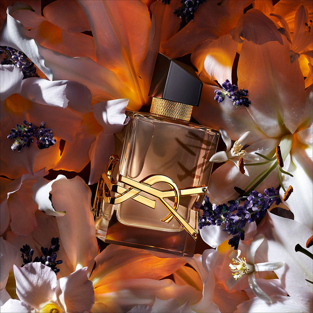 Refect Beauty Yves Saint Laurent Libre Flowers & Flames perfume bottle surrounded by white lilies and lavender sprigs