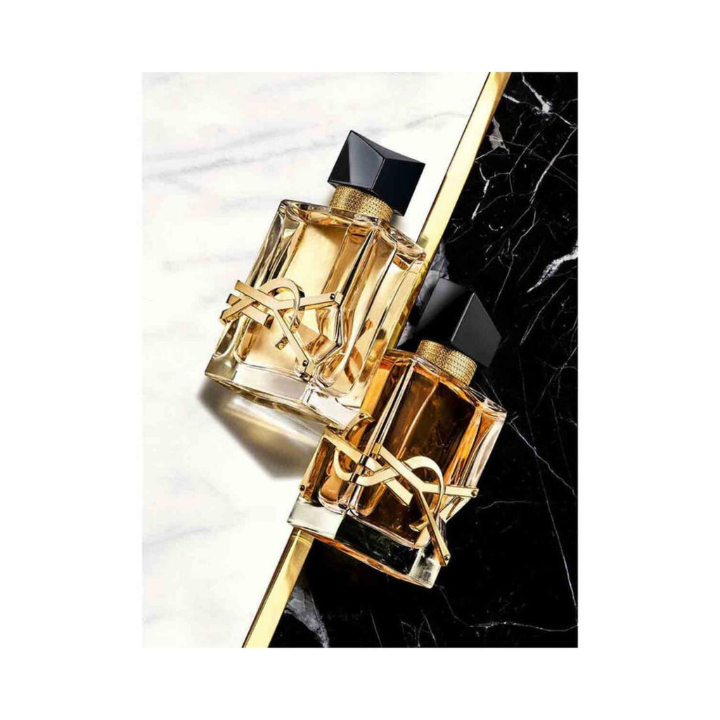 Refect Beauty Yves Saint Laurent Libre Eau de Parfum bottles featuring gold YSL logo on a marble surface