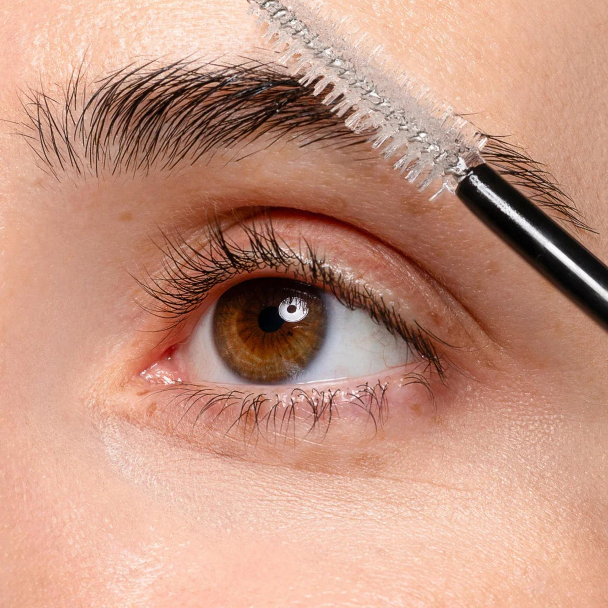 Refect Beauty Zen Routine Fixing Mascara being applied to eyebrows with a spoolie brush for a natural look